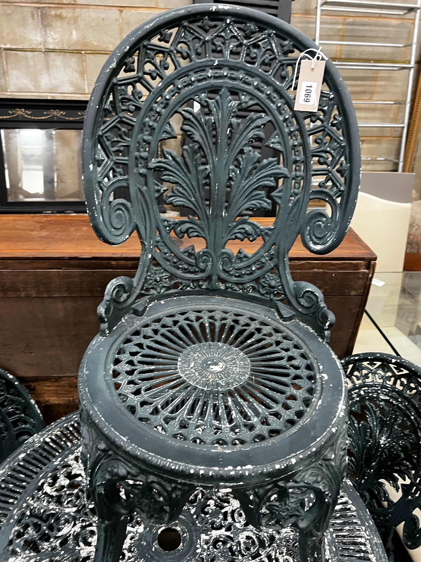 A Victorian style circular aluminium garden table and four chairs, table diameter 80cm height 69cm